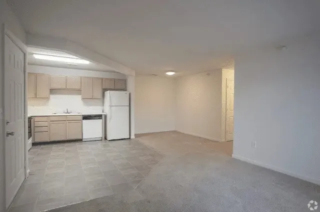a view of a kitchen with a sink and a refrigerator