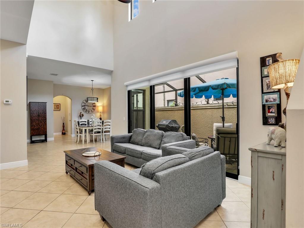 1242 Kendari Terrace Naples, FL 34113 - Photo 2 of 44 a living room with furniture and a large window