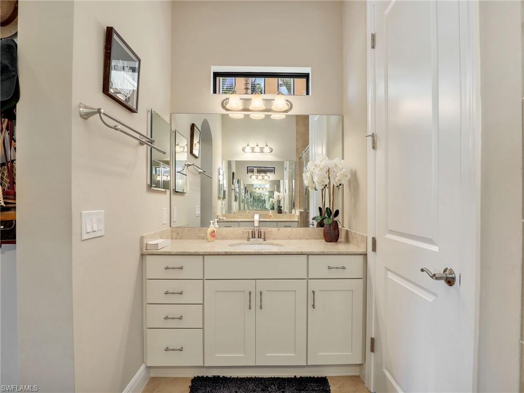 1242 Kendari Terrace Naples, FL 34113 - Photo 21 of 44 a bathroom with a sink and a mirror
