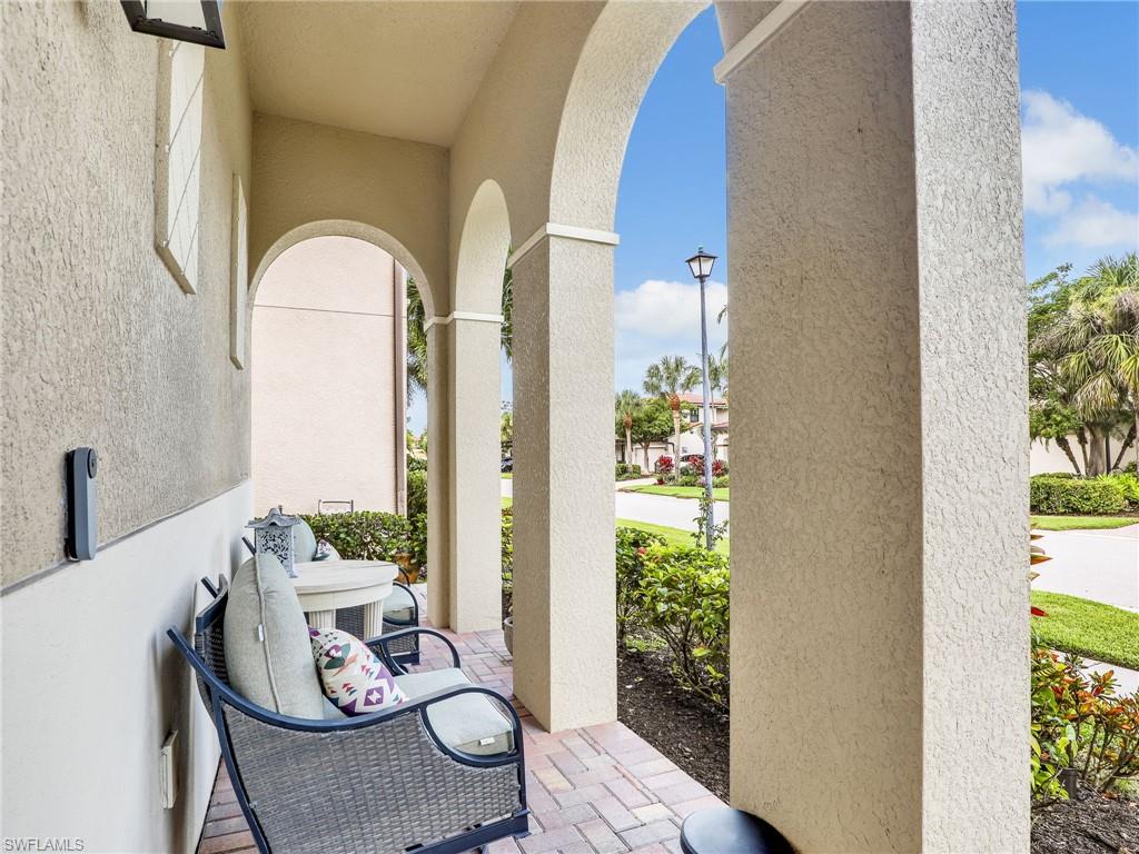 1242 Kendari Terrace Naples, FL 34113 - Photo 3 of 44 a view of a dining room with furniture window and wooden floor