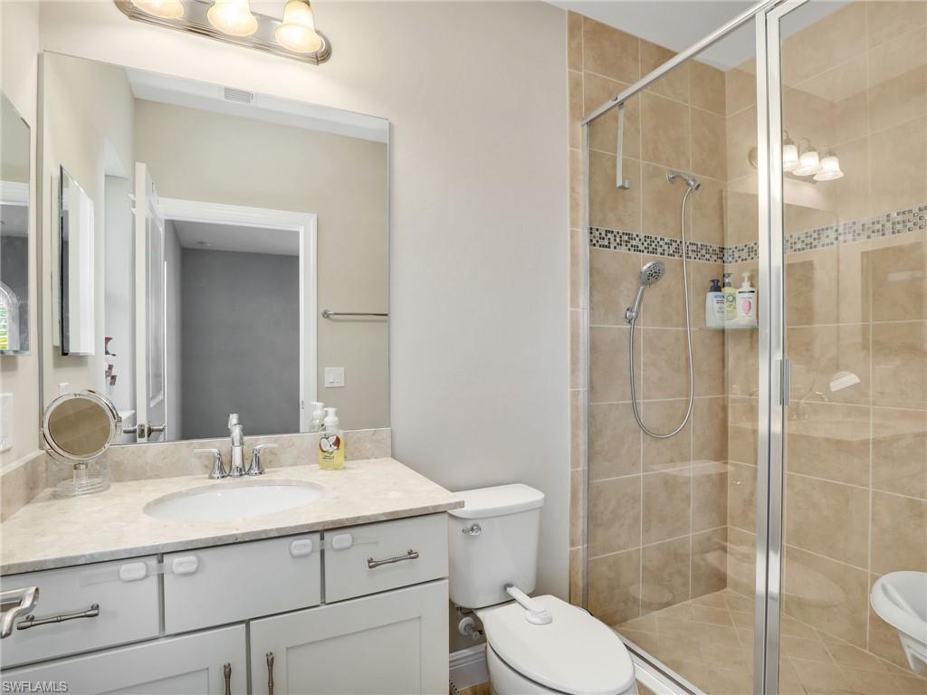 1242 Kendari Terrace Naples, FL 34113 - Photo 32 of 44 a bathroom with a sink shower and a mirror