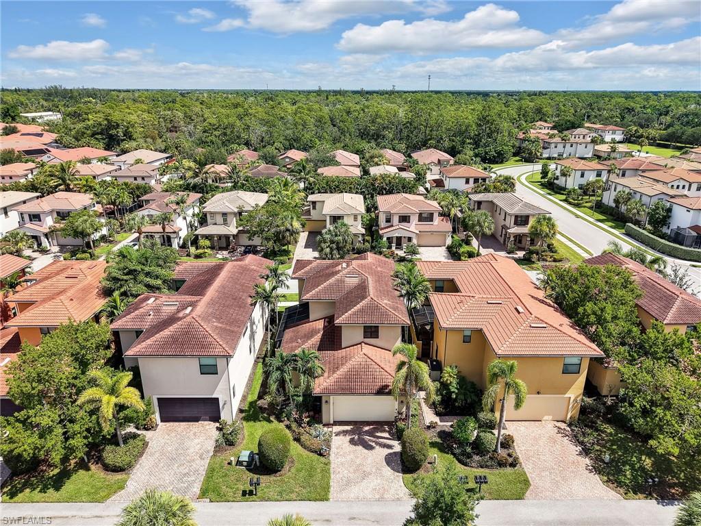 1242 Kendari Terrace Naples, FL 34113 - Photo 44 of 44 an aerial view of residential houses with outdoor space