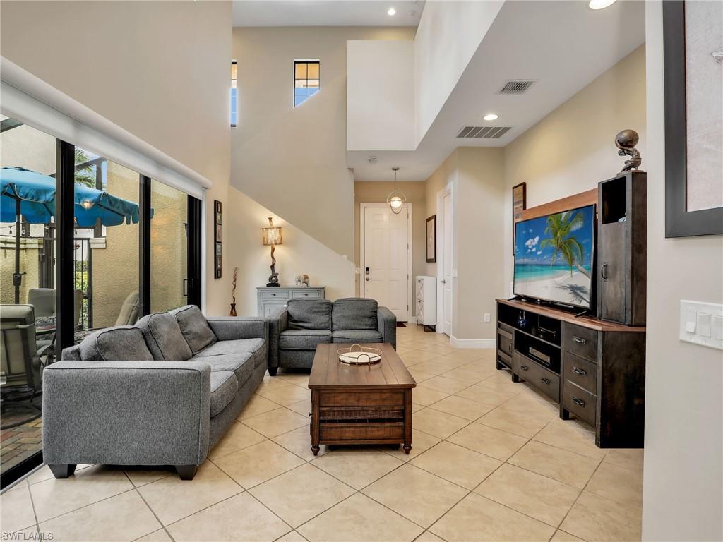 1242 Kendari Terrace Naples, FL 34113 - Photo 5 of 44 a living room with furniture and a flat screen tv