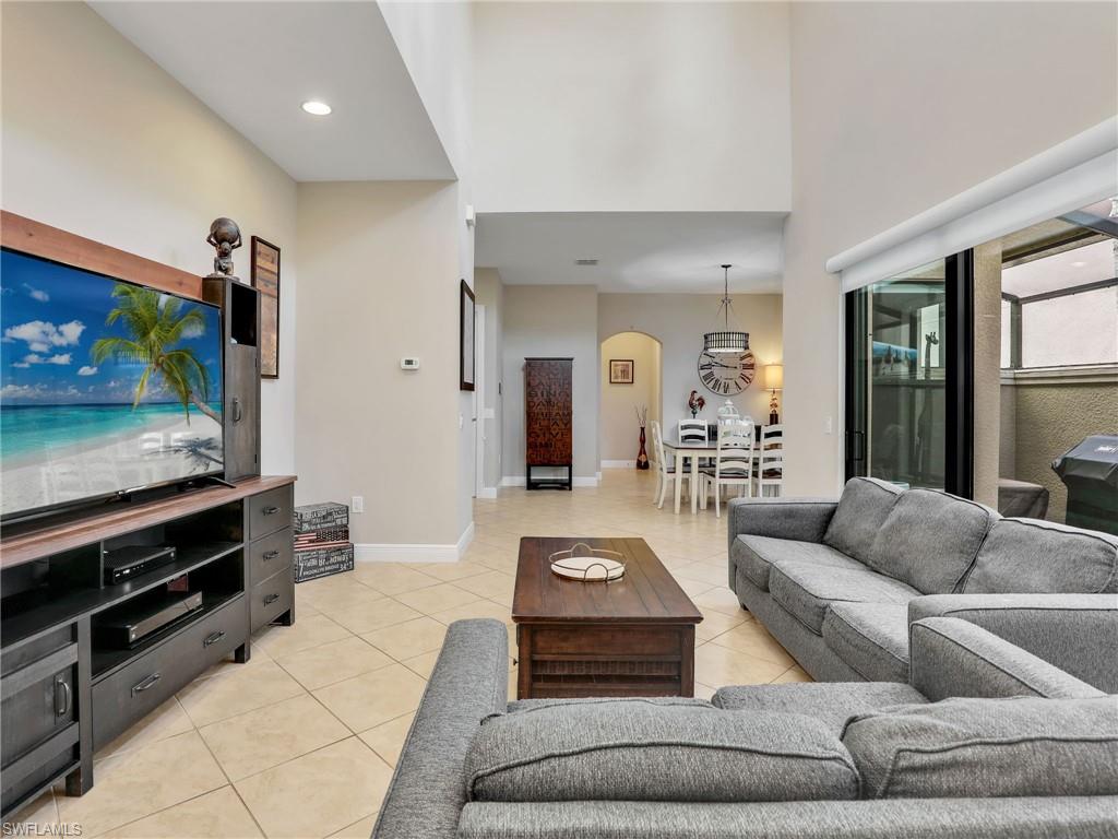 1242 Kendari Terrace Naples, FL 34113 - Photo 6 of 44 a living room with furniture and a flat screen tv