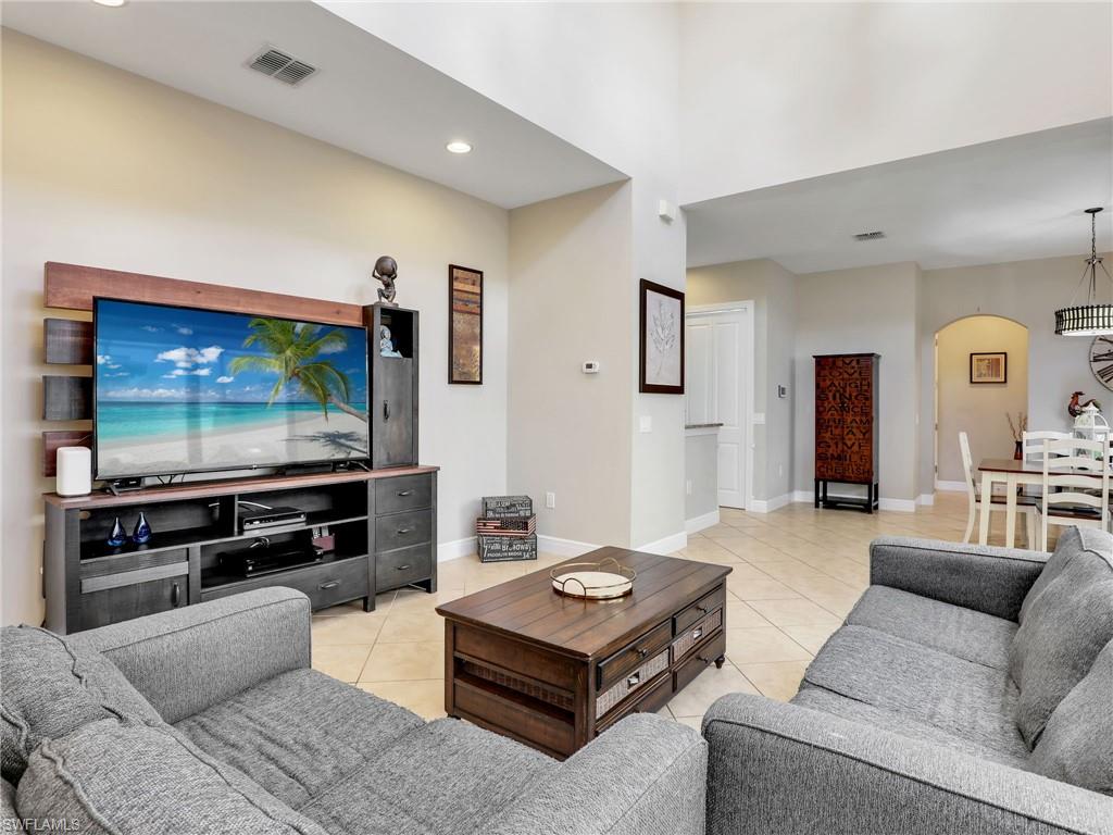 1242 Kendari Terrace Naples, FL 34113 - Photo 8 of 44 a living room with furniture and a flat screen tv