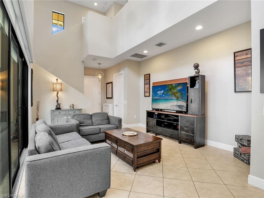 1242 Kendari Terrace Naples, FL 34113 - Photo 9 of 44 a living room with furniture and a flat screen tv