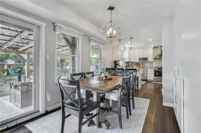 a view of a dining room with furniture large windows and wooden floor