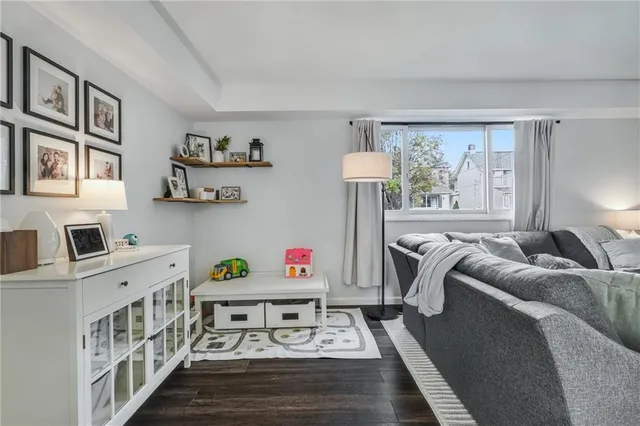 a bedroom with furniture a rug and a window