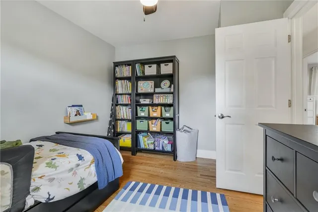 a bedroom with a bed and a book shelf