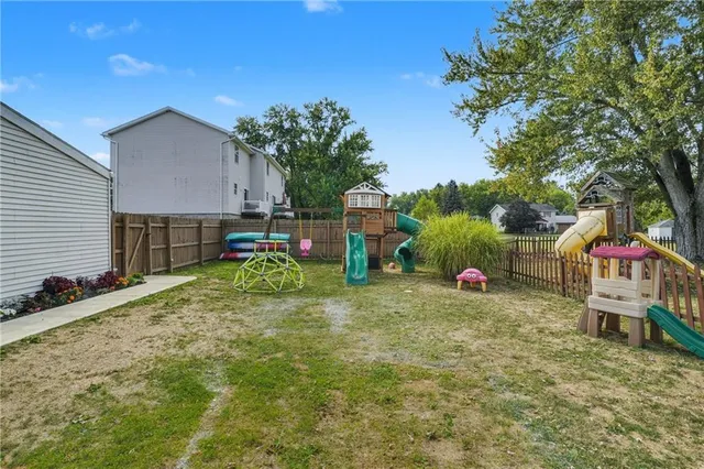 a backyard of a house with table and chairs
