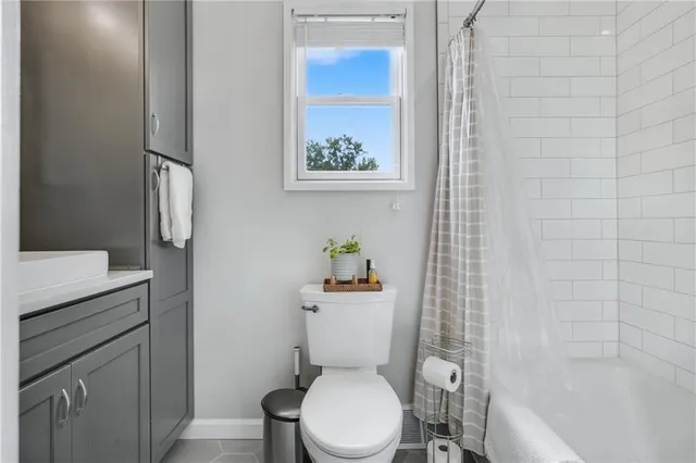 a white toilet sitting next to a bathroom sink