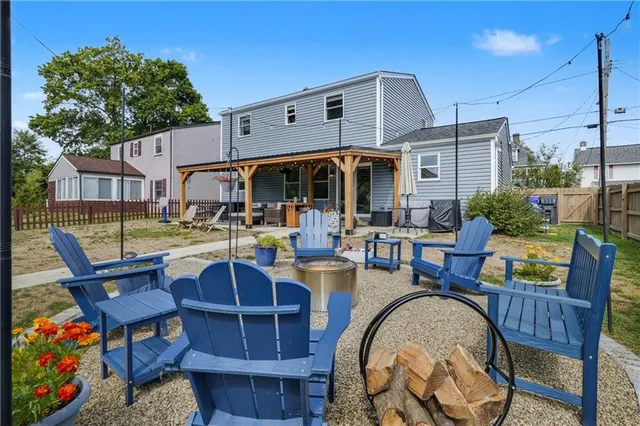 a view of a patio with dining table and chairs