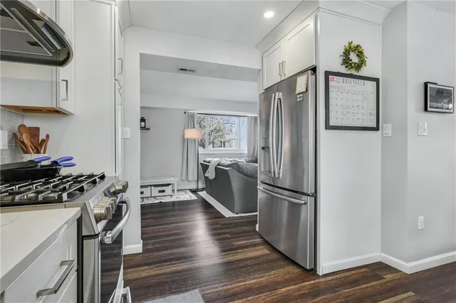 a kitchen with stainless steel appliances granite countertop a refrigerator and a stove