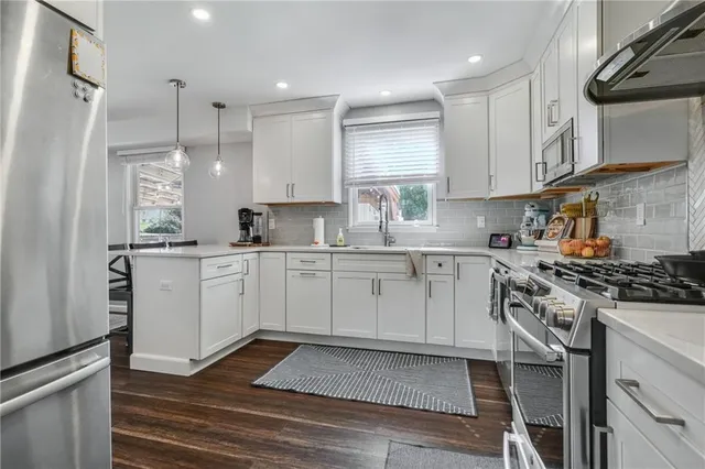 a kitchen with a sink stove and cabinets