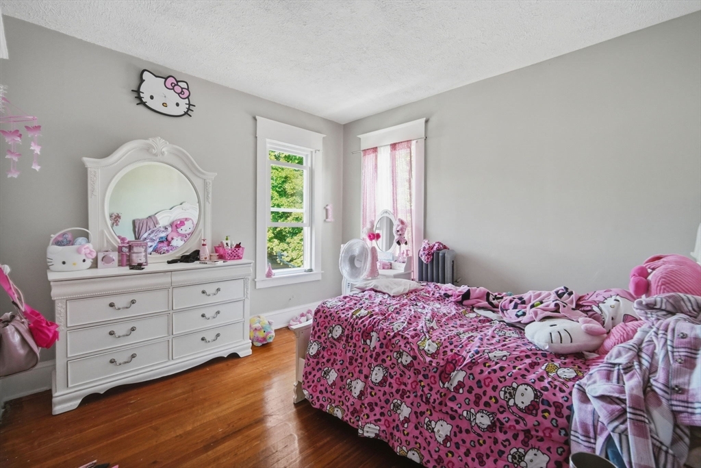 102-104 Cambridge Street Springfield, MA 01109 - Photo 22 of 38 a bedroom with a bed and wooden floor
