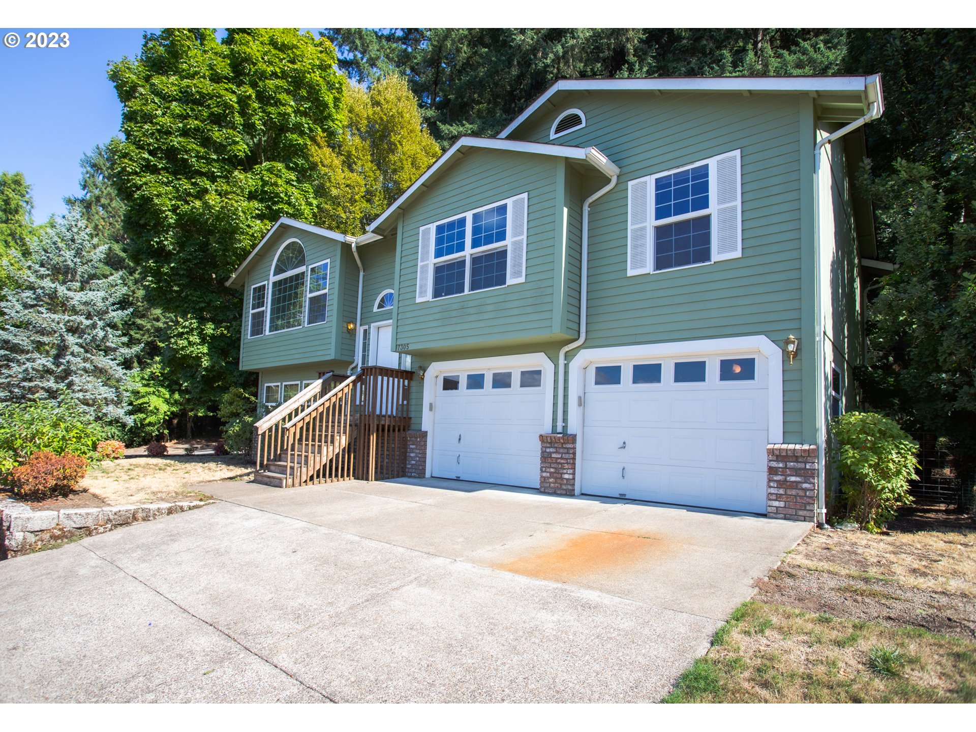 7305 Daisy Street Springfield, OR 97478 - Photo 2 of 23 a front view of a house with a yard and garage