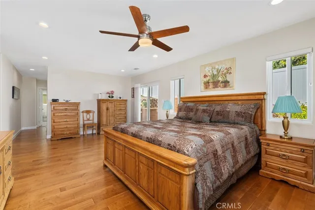 a bedroom with a bed and a ceiling fan
