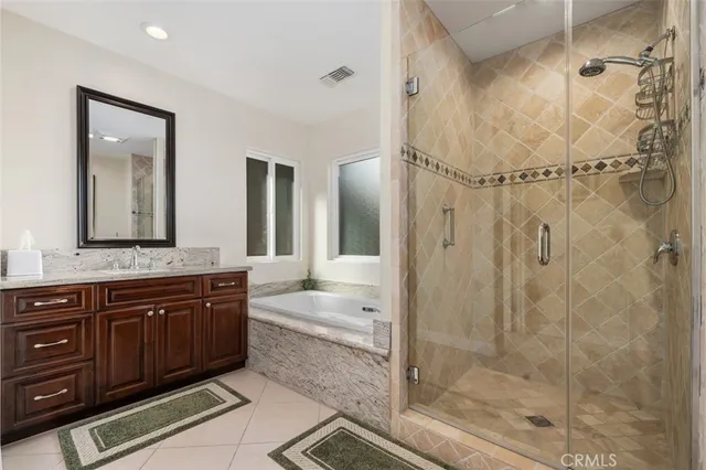 a spacious bathroom with a shower sink and mirror