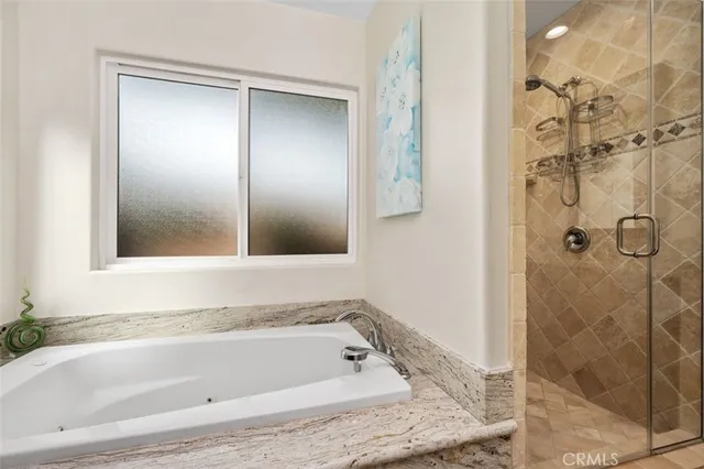 a bathroom with a tub and shower