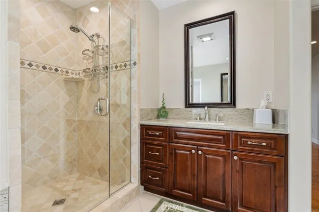 a bathroom with a double vanity sink mirror and shower