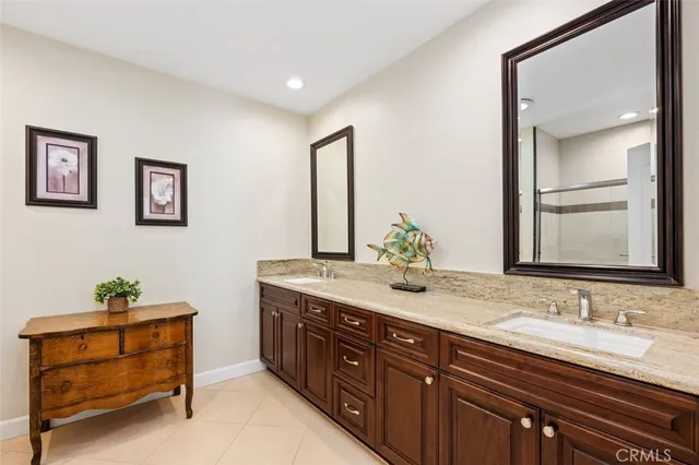 a spacious bathroom with a granite countertop sink and a mirror
