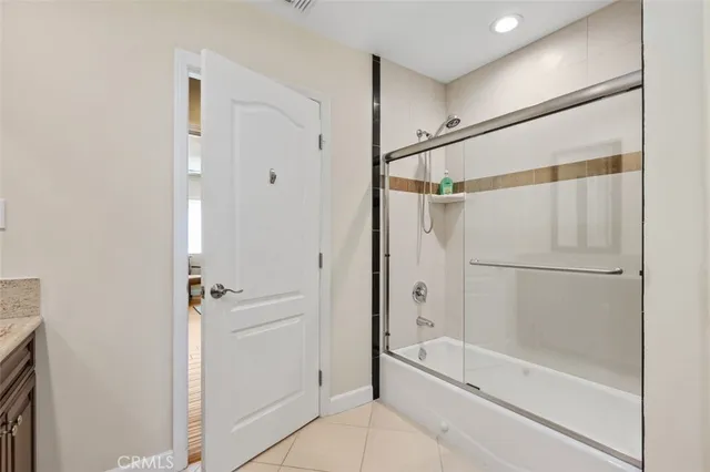 a bathroom with a glass shower door