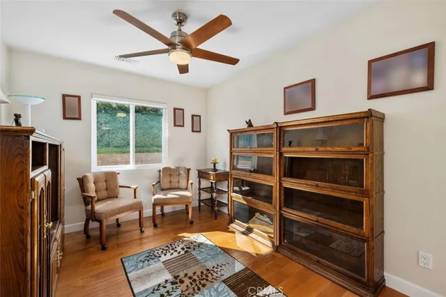a living room with furniture a window and a flat screen tv