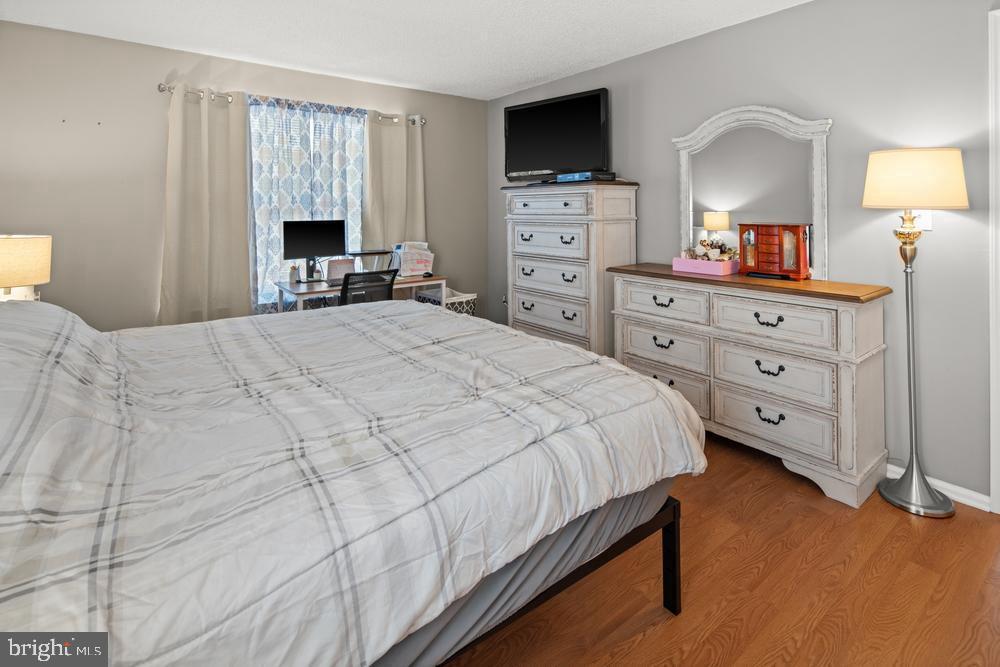 52 Willow Court Hamilton, NJ 08619 - Photo 12 of 23 a bedroom with a bed and a flat screen tv