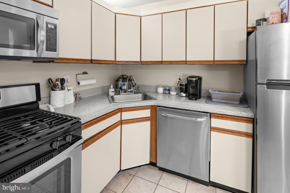 52 Willow Court Hamilton, NJ 08619 - Photo 8 of 23 a kitchen with stainless steel appliances granite countertop a stove a sink and a refrigerator