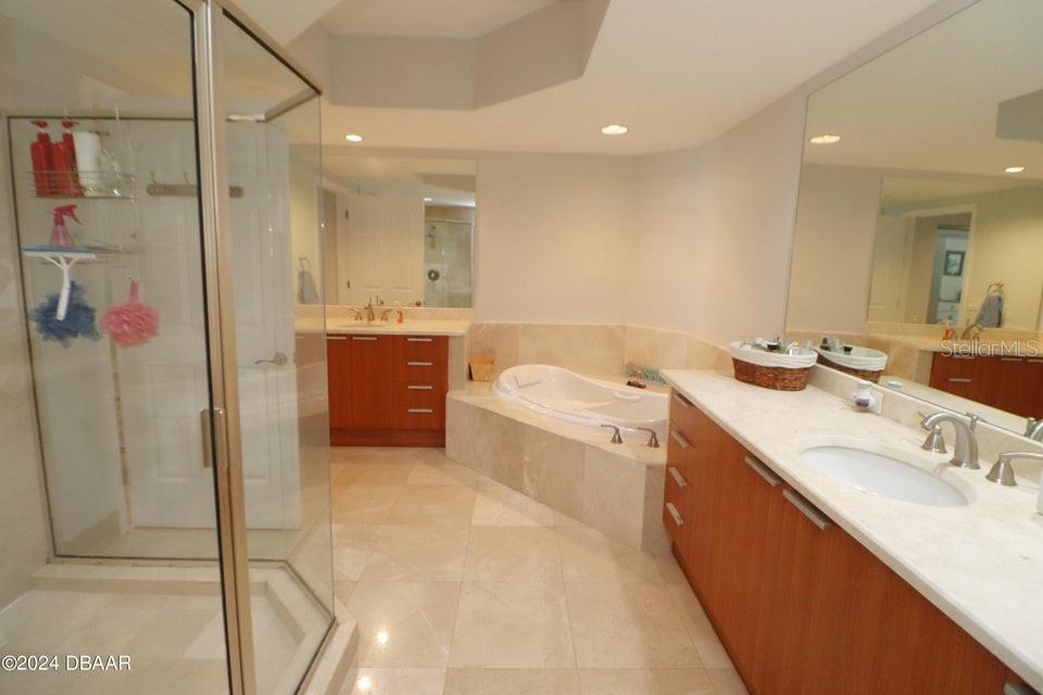 231 Riverside Drive, Unit 11061 Daytona Beach, FL 32117 - Photo 18 of 45 a bathroom with a tub sink and mirror
