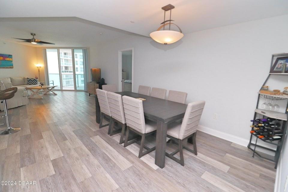 231 Riverside Drive, Unit 11061 Daytona Beach, FL 32117 - Photo 22 of 45 a view of a dining room with furniture and wooden floor