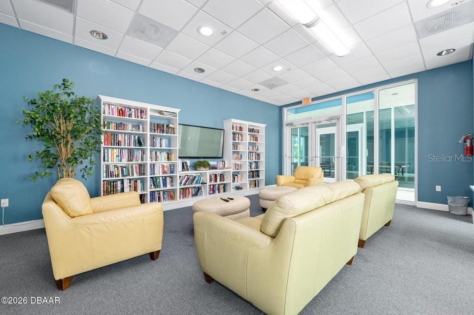 231 Riverside Drive, Unit 11061 Daytona Beach, FL 32117 - Photo 33 of 45 a living room with furniture and a large window