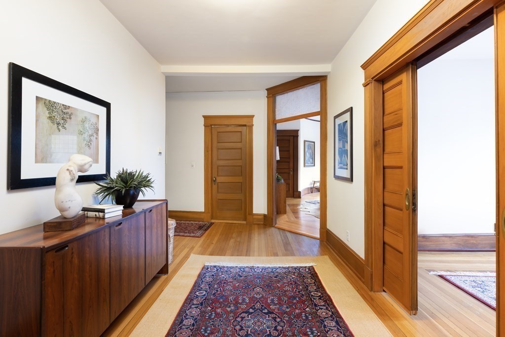 367 Harvard Street, Unit 3 Brookline, MA 02446 - Photo 16 of 25 a hallway with wooden floor
