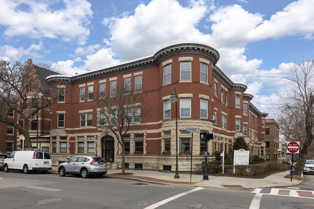367 Harvard Street, Unit 3 Brookline, MA 02446 - Photo 18 of 25 a front view of a building with lot of cars and trees