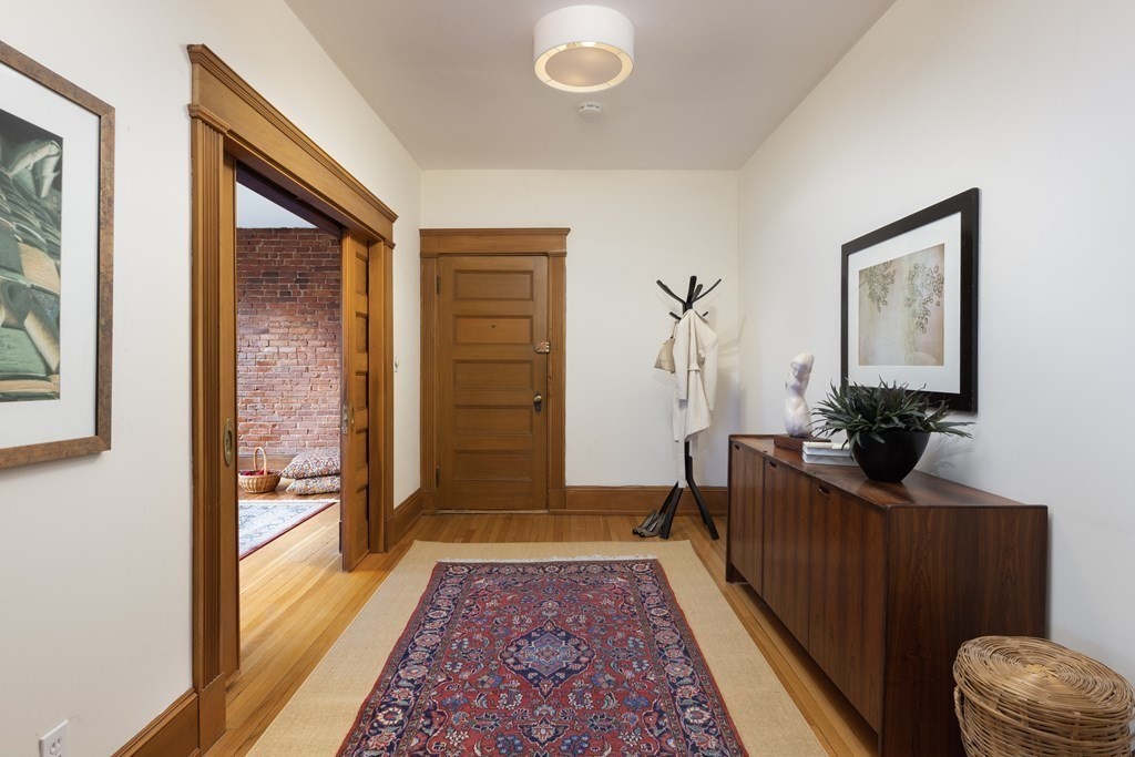 367 Harvard Street, Unit 3 Brookline, MA 02446 - Photo 7 of 25 a living room with furniture and a rug