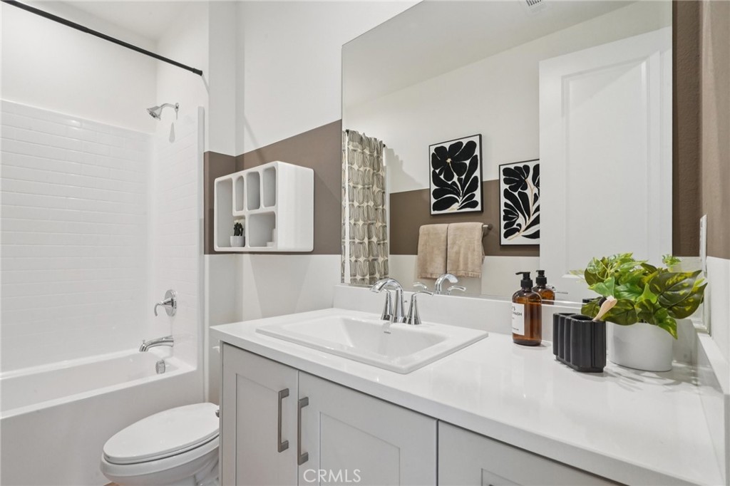 73634 Raphael Drive Palm Desert, CA 92211 - Photo 19 of 24 a bathroom with a granite countertop sink a toilet and shower