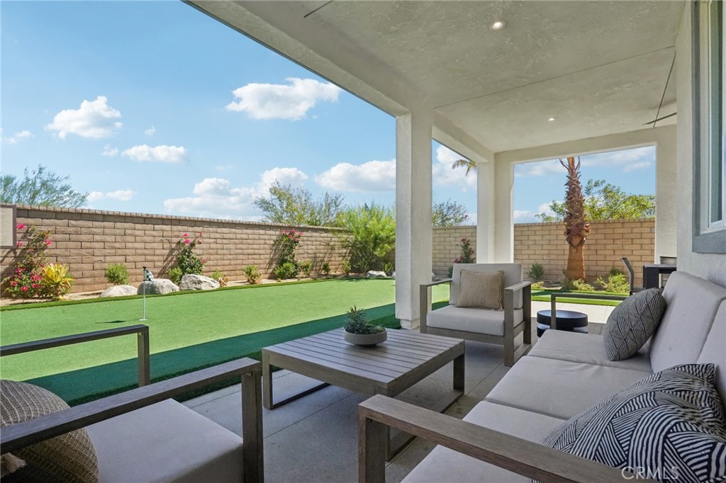 73634 Raphael Drive Palm Desert, CA 92211 - Photo 22 of 24 a living room with furniture and a large window
