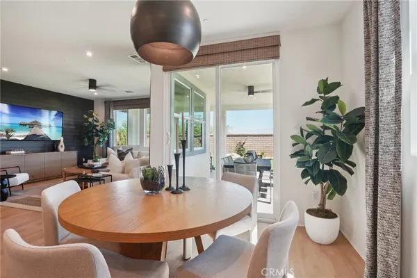 a dining room with furniture and wooden floor