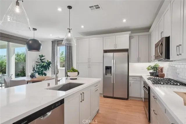 a kitchen with refrigerator cabinets and a sink