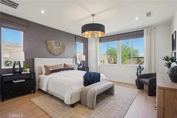 a bedroom with a bed and a chandelier