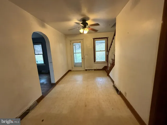 a view of a livingroom with a ceiling fan and window