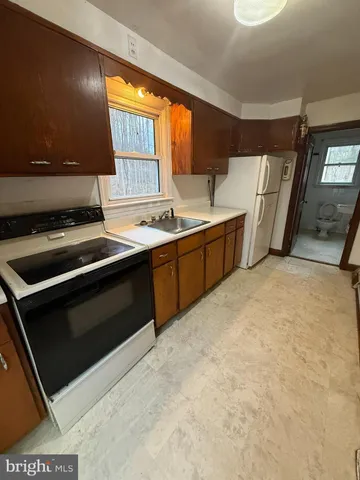 a kitchen that has a sink and a stove