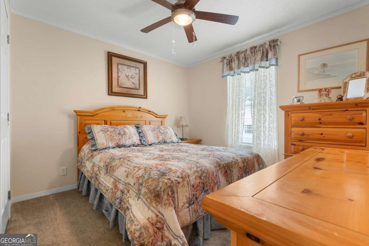 3516 Bennetts Landing Road Millen, GA 30442 - Photo 21 of 34 a bedroom with a bed and a dresser