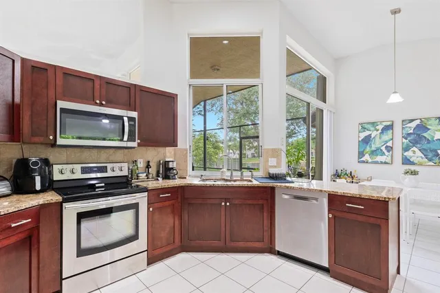 a kitchen with a sink stove top oven and microwave