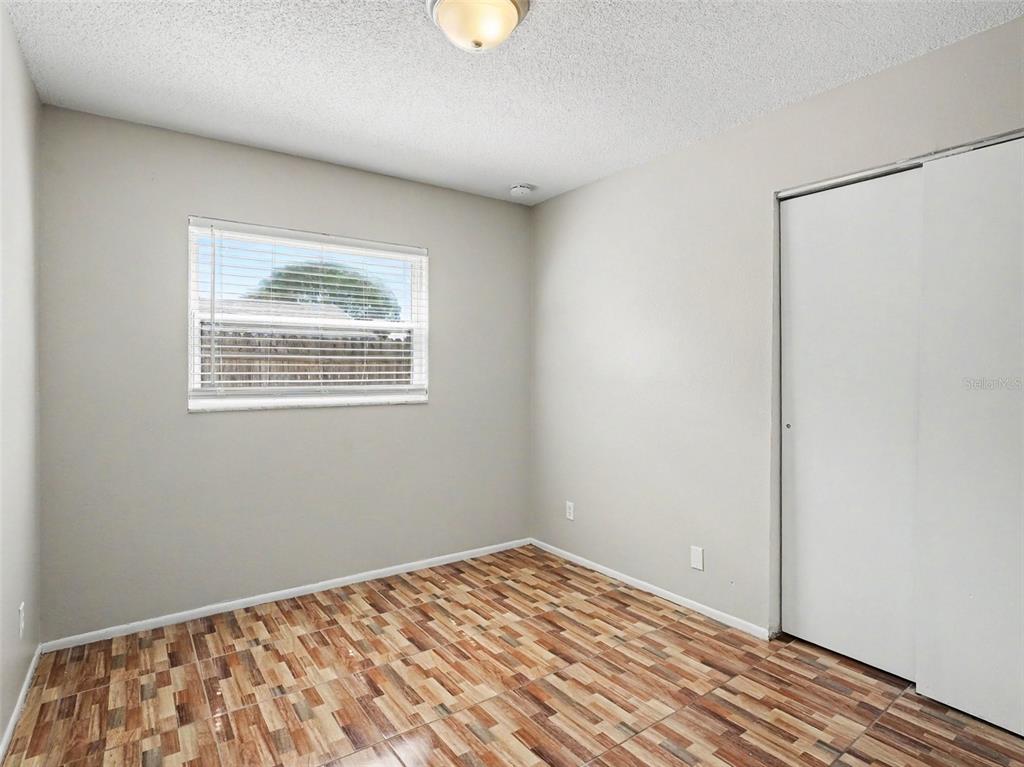 615 Thomas Jefferson Way Orlando, FL 32809 - Photo 13 of 17 a view of a room with a wooden floor and a window