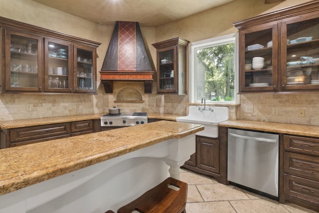 3818 Waterbend Cove Spring, TX 77386 - Photo 12 of 44 a kitchen with a sink stove and cabinets