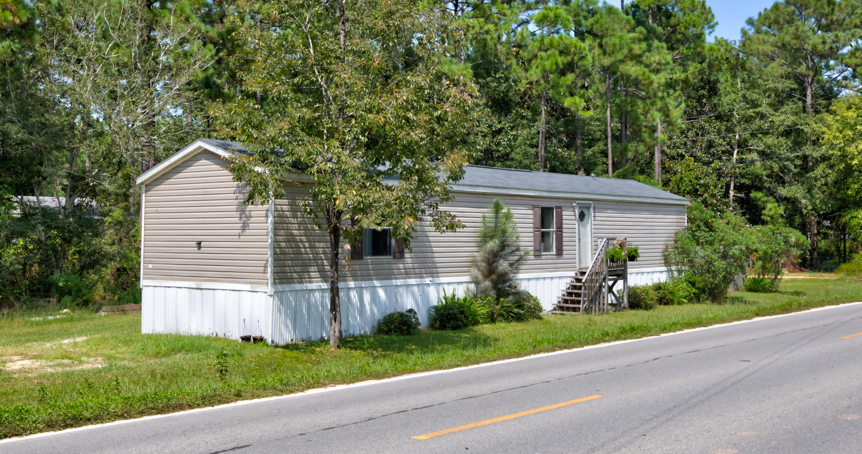 200 Churchill Bayou Road Santa Rosa Beach, FL 32459 - Photo 3 of 4 a front view of a house with a yard and potted plants