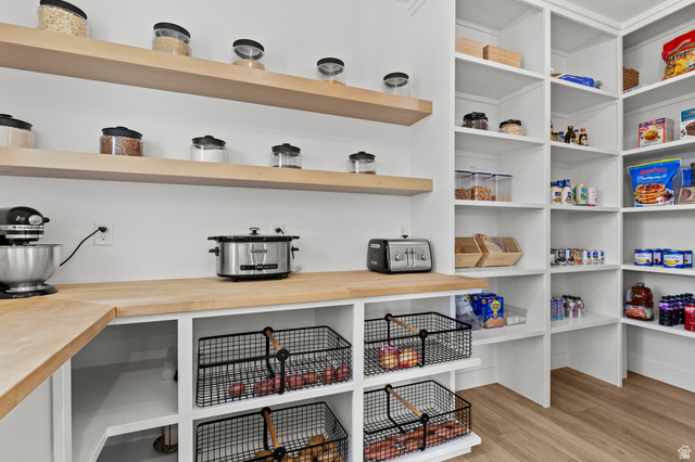 3111 South 1250 West Logan, UT 84321 - Photo 11 of 51 Spacious pantry featuring extensive built-in shelving, natural wood-finish countertops, and integrated wire basket storage