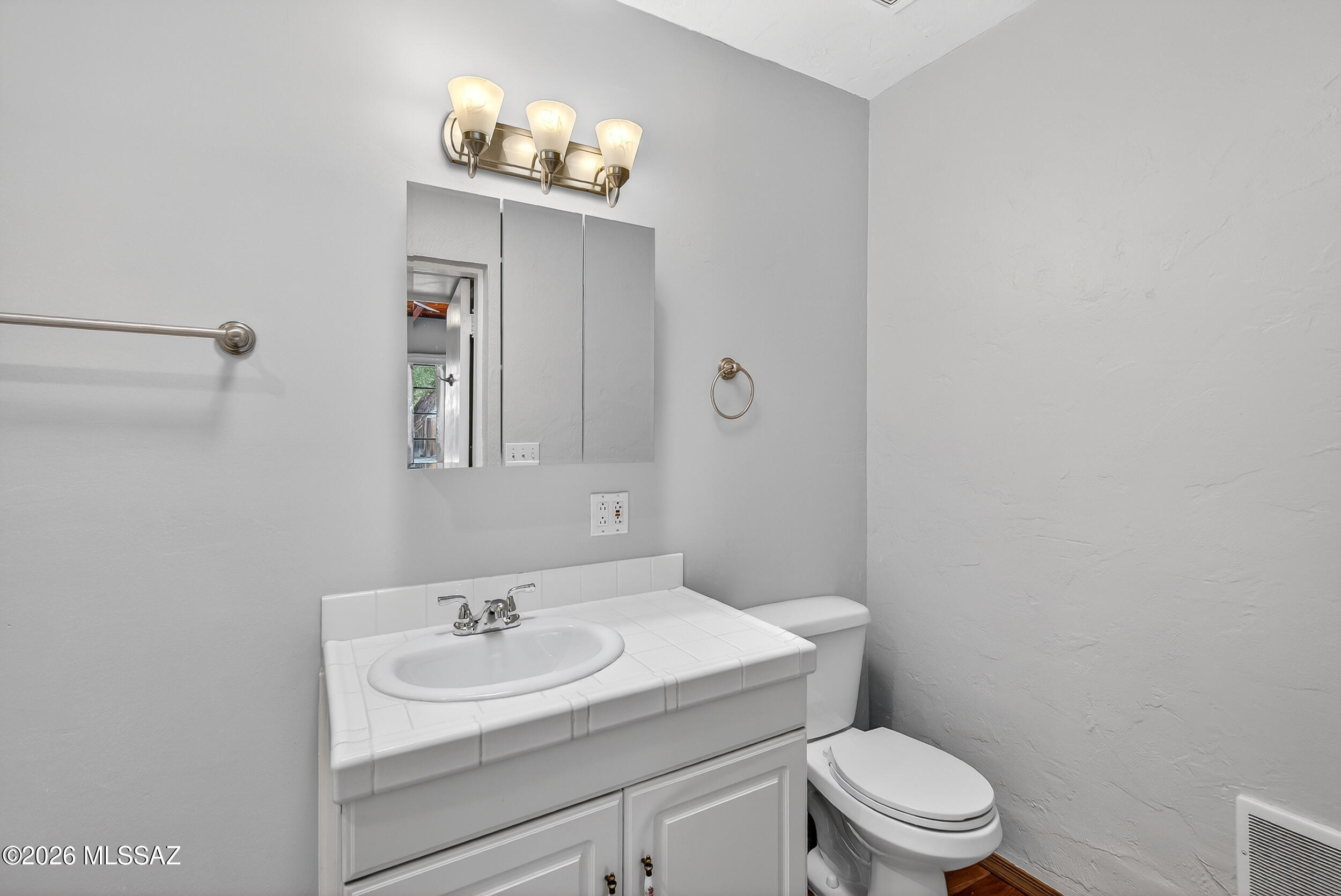 1412 East Spring Street Tucson, AZ 85719 - Photo 28 of 43 a bathroom with a toilet a sink and mirror