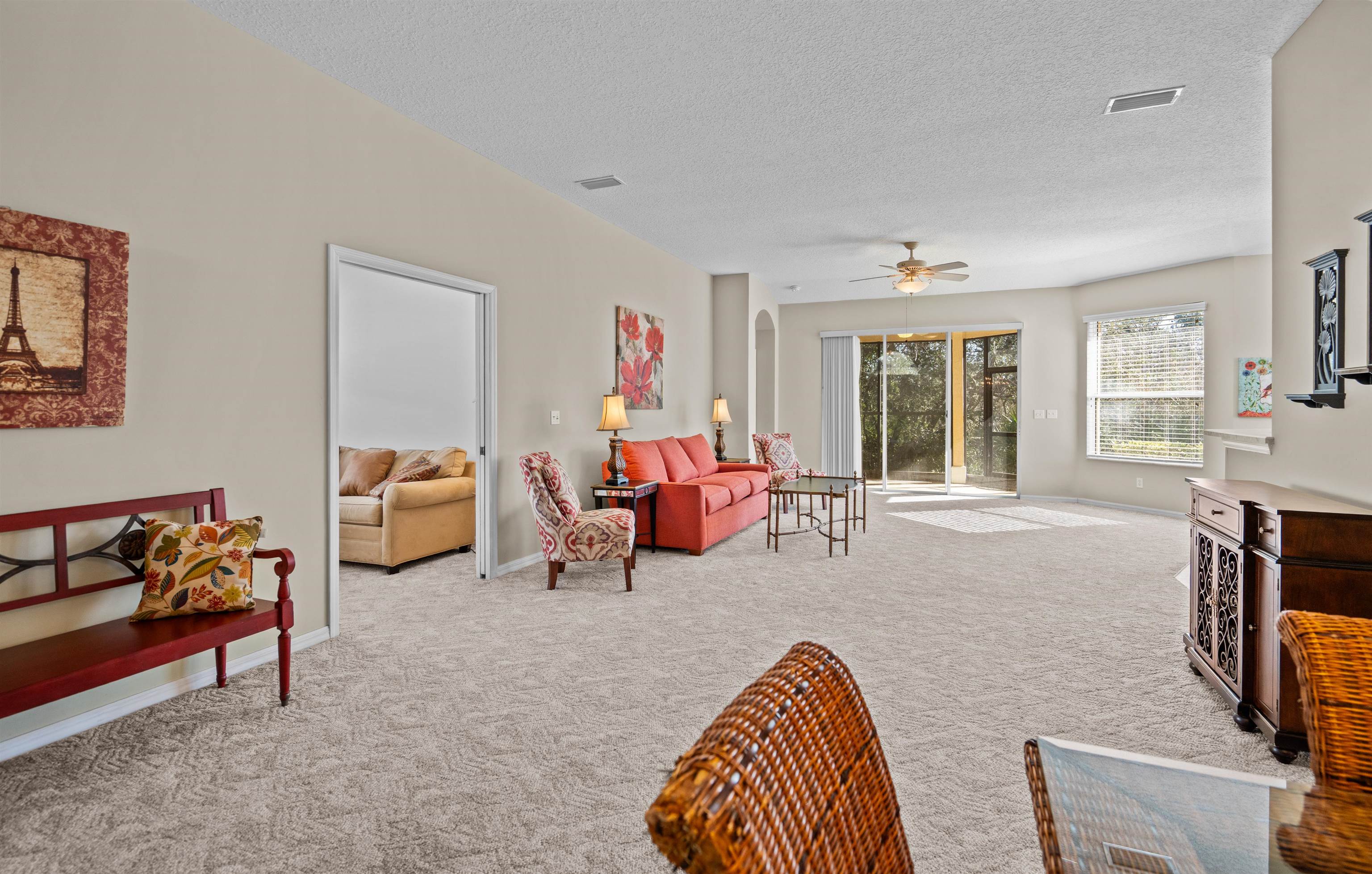 660 Casa Fuerta Lane St. Augustine, FL 32080 - Photo 12 of 52 Living room with arched walkways, light carpet, a textured ceiling, and ceiling fan